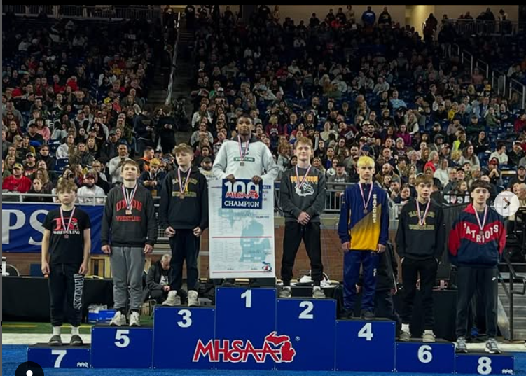  Champion Cyrus Woodberry, standing next to his competitors